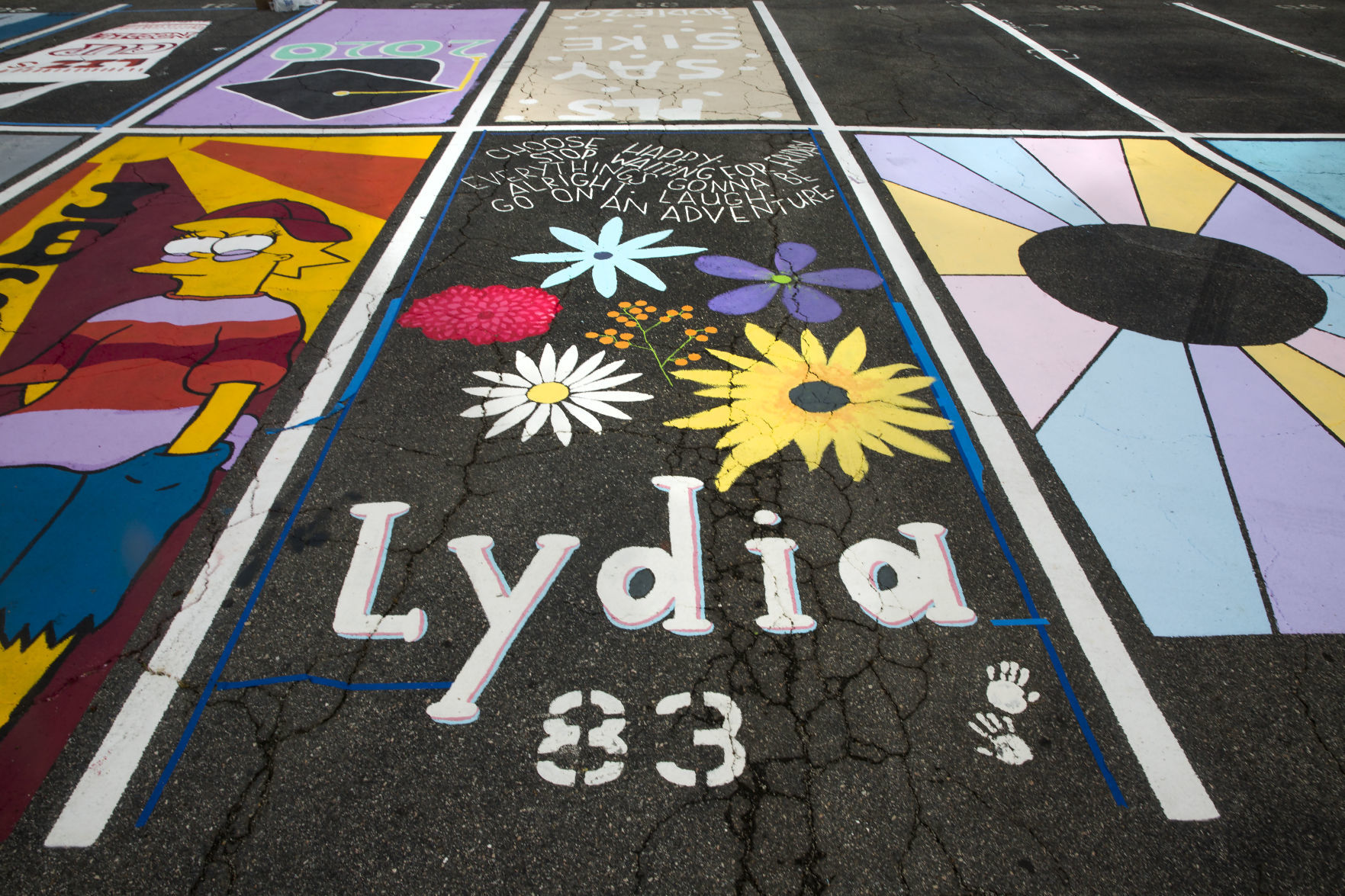 Students painting their parking spaces